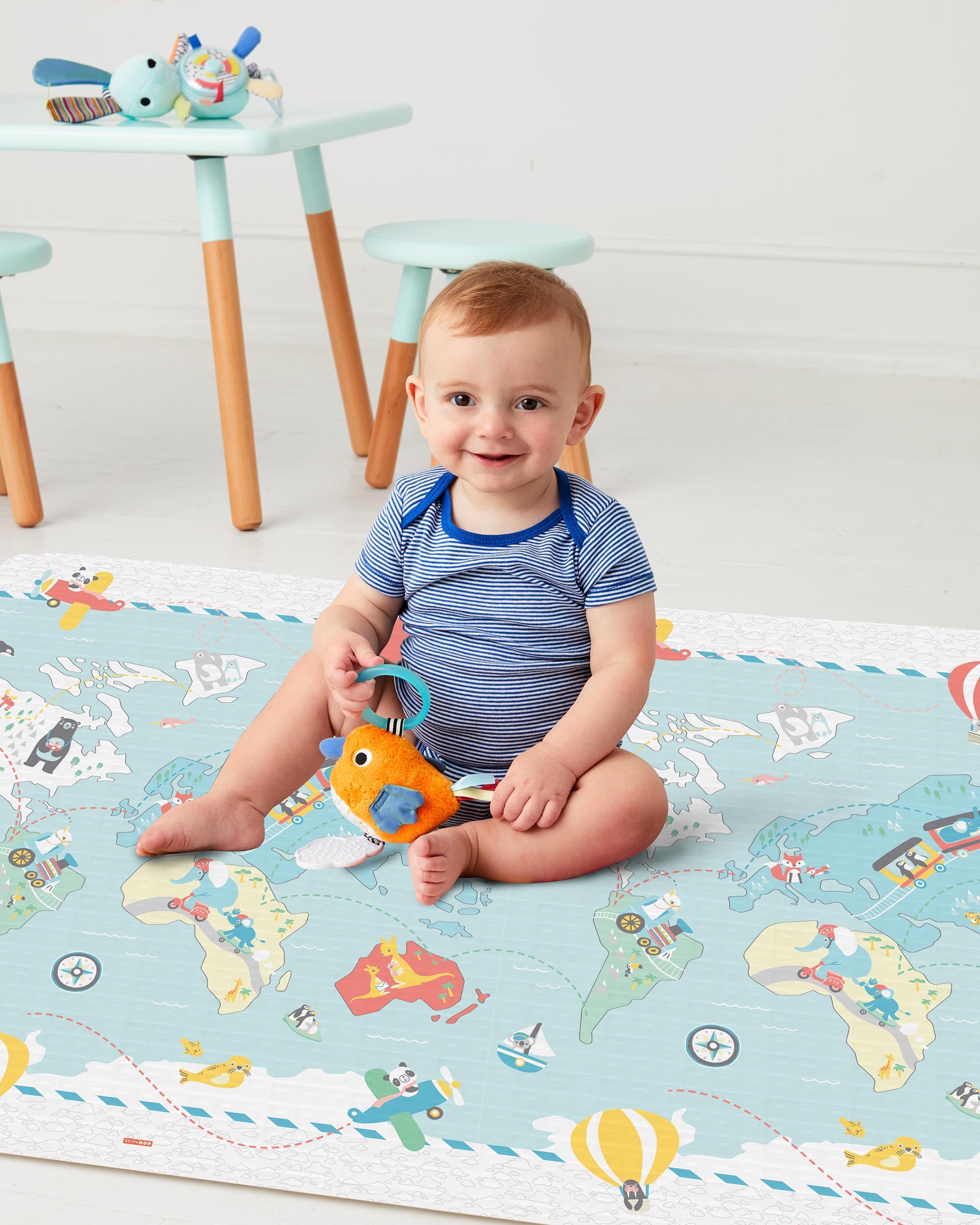 Toddler on the Skip Hop Doubleplay Reversible Playmat Little Travellers